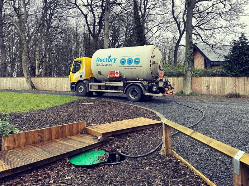 A Rectory Gas Supplies tanker parked on a driveway while refilling an underground LPG tank