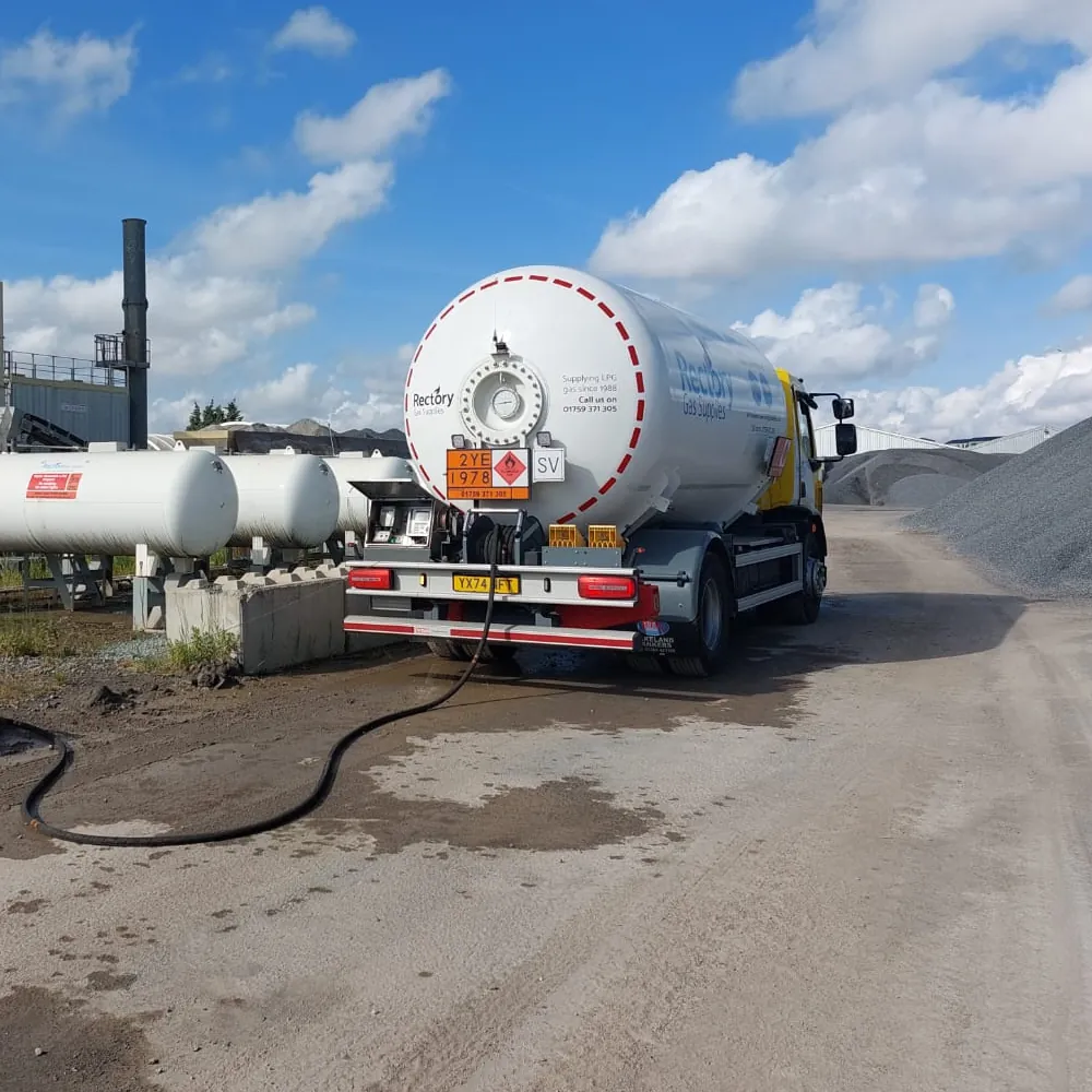 A Rectory Gas Supplies tanker refilling LPG tanks beside an asphalt plant at an industrial site