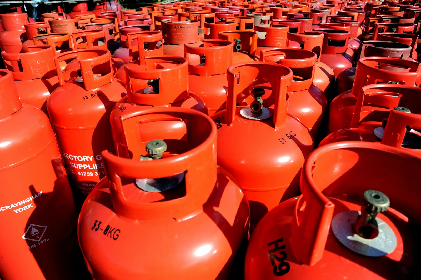 Rows of red LPG gas cylinders lined up together